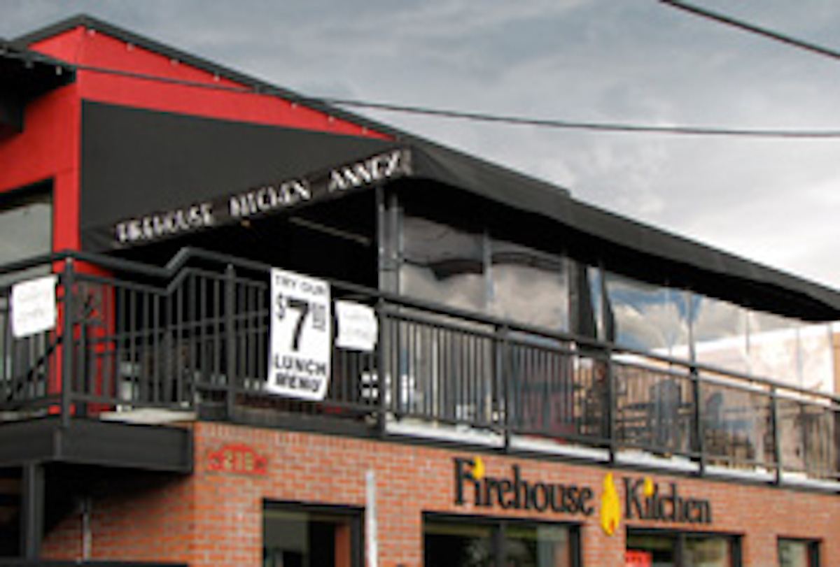 Branded commercial awning with hand-painted restaurant graphics
