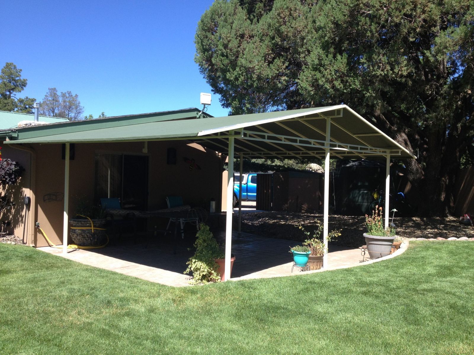 Custom steel-frame patio cover over a backyard patio