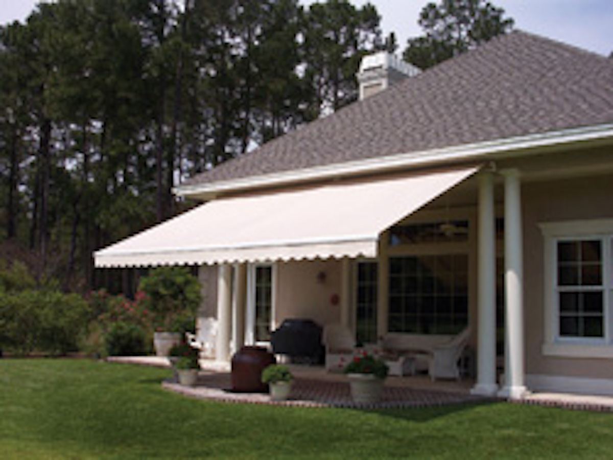 Retractable fabric awning extended over a residential patio